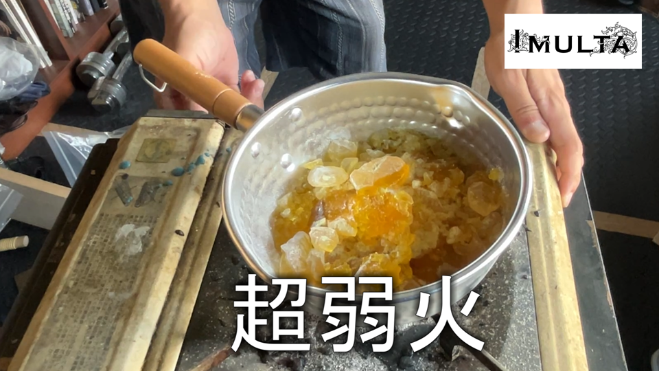 彫金作業で金属を固定するために使う松脂を鍋で煮込む工程。焦げ付きを防ぐために超弱火で加熱し、柔らかさを調整している様子